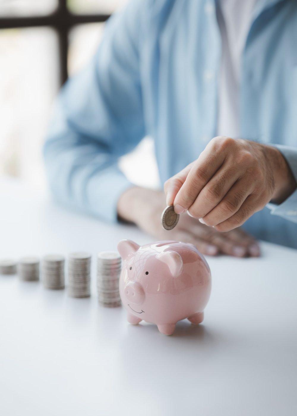 Nivesh Gullak - person with pile of coins and piggy bank money saving concept for future use and financial stabilit